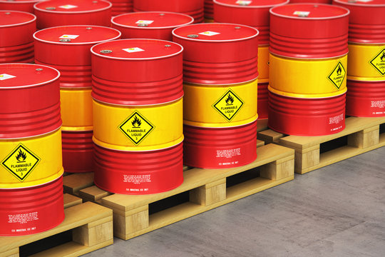 Group of red oil drums on shipping pallets in the storage warehouse