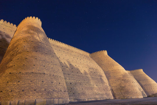 Night view of historical Ark fortess in Bukhara city, Uzbekistan. Wall of the Bukhara Fortress, the Ark.
