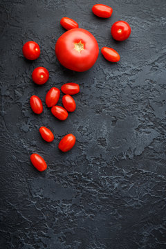 Fresh tomato on black background