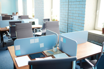 Several empty workplaces in open space office during coffee break or lunch break