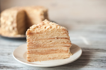 Beautiful appetizing homemade puff cake Napoleon. Piece of puff pastry on a white plate