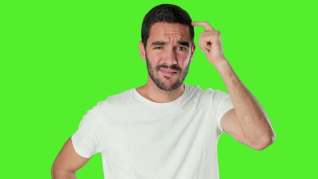 Confused young man on chroma screen