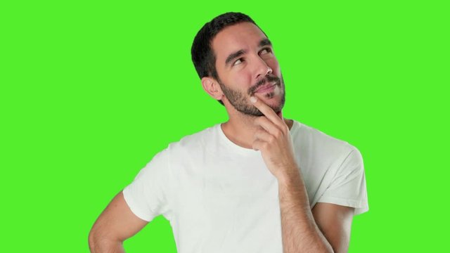 Young man wondering on chroma screen