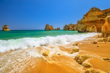 Pillars and sandstone formations seen from Praia do Camilo, Lagos, Algarve, Portugal. Camilo Beach...