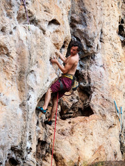 Young strong guy climbing / leading topless in Thailand - Krabi, Tonsai Beach
