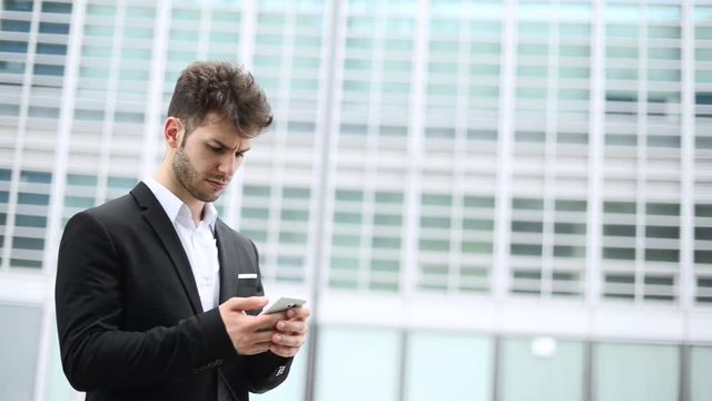 Young manager using a smartphone  outdoor