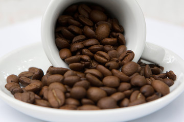 White ceramic cup of coffee beans brown color aroma arabica seeds on plate background wallpaper
