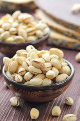 Pistachios nuts on wooden table.