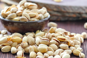 Pistachios nuts on wooden table.