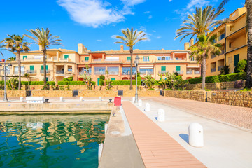 Fototapeta na wymiar Promenade with beautiful colorful houses in Sotogrande marina, Andalusia, Spain