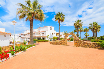 Fototapeta na wymiar White houses and tropical plants in small coastal village near Marbella, Costa del Sol, Spain