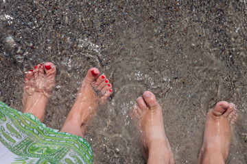 feet men and women at the sea. sea tour. the legs of the water