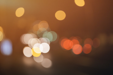 Blurry night lights in the city made up of yellow, white and red colors