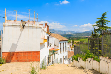 Narrow street with colorful house facades in old town of Ronda, Andalusia, Spain