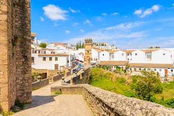 Walkway from castle to Andalusian village of Ronda with white houses, Spain