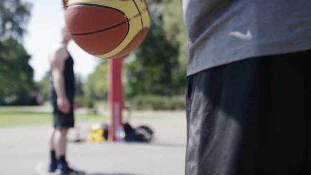 Basketball being bounced by a player at the free throw line, in slow motion 