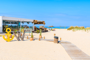TARIFA BEACH, SPAIN - MAY 11, 2018: Restaurant on sandy beach on sunny beautiful day. Andalusia is hottest province of the country and attracts many tourists.