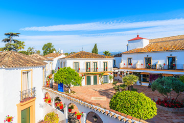 MARBELLA, SPAIN - MAY 7, 2018: View of apartment hotel with typical architecture of small Spanish village. Andalusia is the only European region with both Mediterranean and Atlantic coastlines.