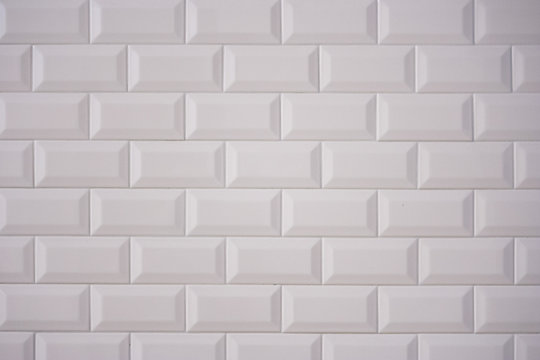 Ceramic rectangular white tile laid horizontally. Glazed white ceramic brick for interior walls