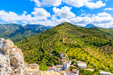 View of mountains and houses on green hills in Zahara de la Sierra village, Andalusia, Spain © pkazmierczak