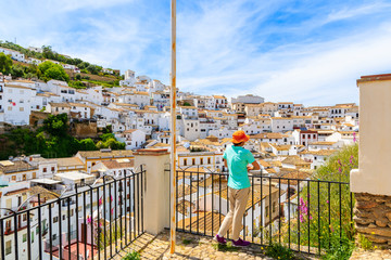 Woman tourist standing on viewpoint and looking at beautiful white village of Sentinel de las Bodegas, Andalusia, Spain © pkazmierczak