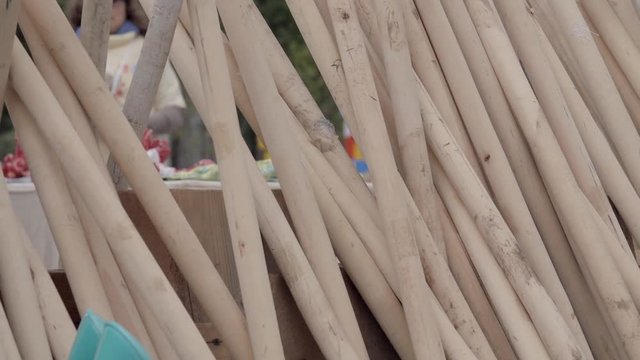 Many bayonet shovels with wooden handles outdoors in spring time, household equipment for cleaning, arrangement of territory, digging of the earth.