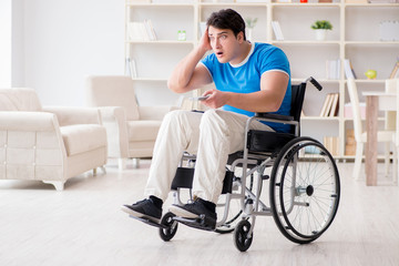 Fototapeta na wymiar Disabled man watching sports on tv