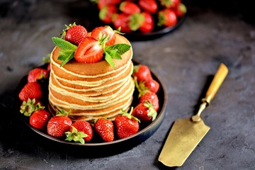 Delicious pancakes with fresh organic strawberries and mint