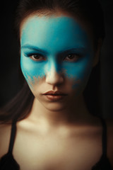 Beautiful asian girl is posing with creative blue makeup