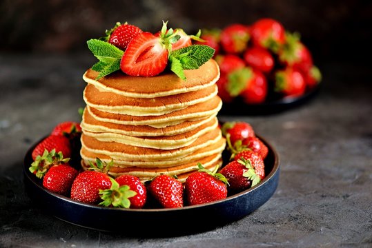 Delicious pancakes with fresh organic strawberries and mint