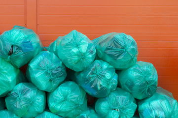 Fototapeta na wymiar Green bags full of plastic for recycling