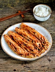 Organic kimchi with hot peppers and rice on an old wooden background. rustic style meal. Korean food.
