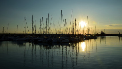 Fototapeta na wymiar Harbour, the boat haven at the sunrise