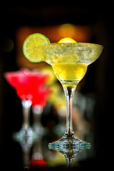 Glasses of cocktails on bar background
