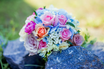 bouquet of flowers for the bride white blue and green on the background of a glass of water on a wedding day