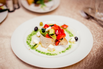 salad of vegetables and meat on a beautiful white plate