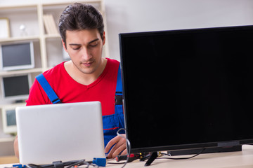 Professional repair engineer repairing broken tv