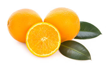 Fresh juicy oranges with slices and green leaves. Isolated on a white background.