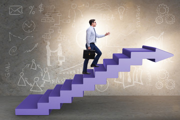 Fototapeta na wymiar Businessman climbing career ladder in business concept