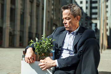 Grief stricken. Grief stricken elderly wrinkled business man feeling very bad after being fired...