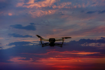 Drone flying over a sunset sky with light clouds