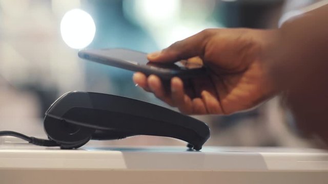 Close up hand african american man use credit card terminal store machine hand commerce shopping money technology retail paying business typing buy transaction pay market cashier customer banking