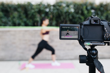 Young female vlogger recording content for her video blog. Fitness and healthy lifestyle concept.