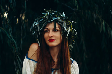 Portrait of young woman with chaplet on a head