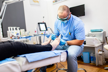 Toenail fungus treatment with foot laser at laser nail therapy clinic.