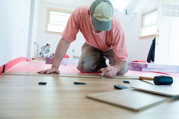 Homeowner measuring for DIY Laminate Floor installation