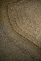 Abstract colorful patterns of sand on Oregon Coast beach