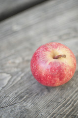 small apple on wooden table