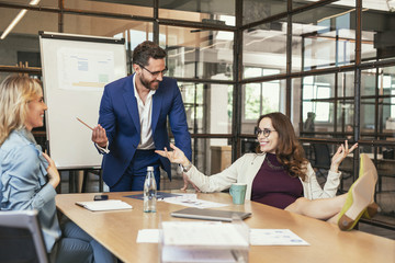 Profitable business. Glad three colleagues having meeting and joking