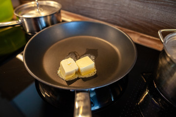 melting butter in a pan on a hot plate